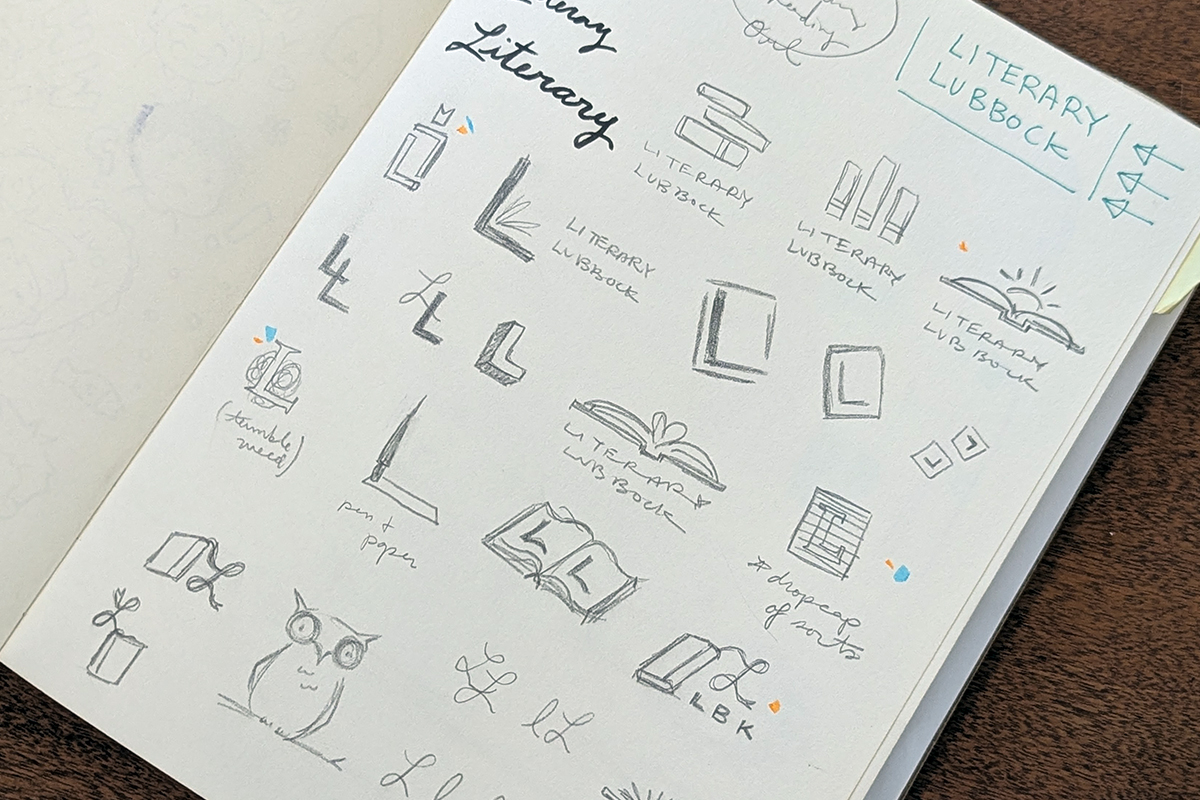 A photo of a sketchbook with concepts for the logo.